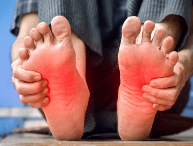 Feet with highlighted pain zones on the soles, illustrating foot pain