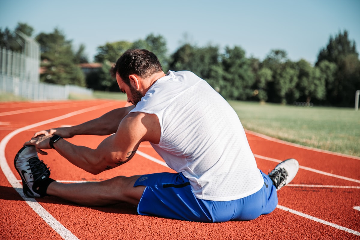Person holding an injured, strained arm muscle